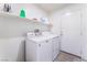 Well-lit laundry room with modern appliances and storage shelves at 2117 Mountain Sunset Ave, North Las Vegas, NV 89031