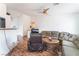 Living room with laminate flooring, natural lighting, and neutral colored furniture at 2117 Mountain Sunset Ave, North Las Vegas, NV 89031
