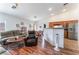 Open concept living room, dining area, and kitchen featuring laminate flooring at 2117 Mountain Sunset Ave, North Las Vegas, NV 89031