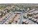 Expansive aerial view showcasing a well-planned community with lush landscaping, pools, and tennis courts at 236 Dog Leg Dr, Las Vegas, NV 89148
