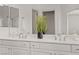Bathroom featuring dual sinks, white cabinetry, and modern fixtures at 236 Dog Leg Dr, Las Vegas, NV 89148