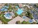 Expansive community pool area featuring a water park, tennis courts, and other recreational amenities amidst lush landscaping at 236 Dog Leg Dr, Las Vegas, NV 89148