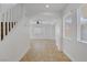 Bright entryway with tile flooring, white walls, staircase, and an arched doorway to the living area at 236 Dog Leg Dr, Las Vegas, NV 89148