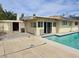 Backyard with a covered patio area, a swimming pool, and views of the surrounding landscape at 2501 Capistrano Ave, Las Vegas, NV 89121