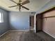 Bedroom featuring carpet, ceiling fan with lights, window with natural light, and closet at 2501 Capistrano Ave, Las Vegas, NV 89121