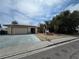 View of the house with a desert landscape, mature trees and a driveway that leads to a two-car garage at 2501 Capistrano Ave, Las Vegas, NV 89121