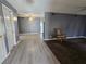 Open floor plan with light wood flooring and rocking chair next to carpeted living room at 2501 Capistrano Ave, Las Vegas, NV 89121