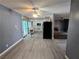 View of the living room and kitchen area, with updated vinyl flooring, and a ceiling fan at 2501 Capistrano Ave, Las Vegas, NV 89121