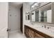 Bathroom features a double sink vanity, storage cabinet, and shower with glass doors at 2721 Family Ct, Las Vegas, NV 89117