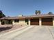 Beautiful brick home featuring a wide driveway leading to a two-car garage and meticulous desert landscaping at 2721 Family Ct, Las Vegas, NV 89117