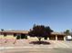 Charming single-story home featuring a well-manicured front yard with desert landscaping and a beautiful shade tree at 2721 Family Ct, Las Vegas, NV 89117
