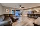 Spacious living room with wood floors, ceiling fan, bar seating and access to the pool at 2721 Family Ct, Las Vegas, NV 89117