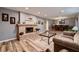 Open-concept living space with brick fireplace, wood floors, and neutral color palette at 2721 Family Ct, Las Vegas, NV 89117