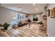 Bright living room featuring wood floors, a comfortable sofa and shuttered windows at 2721 Family Ct, Las Vegas, NV 89117