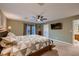 Main bedroom with ceiling fan, private door to backyard and ensuite bathroom at 2721 Family Ct, Las Vegas, NV 89117