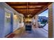Covered patio with exposed wood beams, a foosball table, hammock, and comfortable seating at 2721 Family Ct, Las Vegas, NV 89117