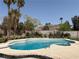 Inviting backyard pool and spa area with mature landscaping and privacy fence, perfect for outdoor enjoyment at 2721 Family Ct, Las Vegas, NV 89117