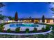 An in-ground pool is surrounded by landscaping and patio umbrellas at the rear of this well-maintained home at 2721 Family Ct, Las Vegas, NV 89117
