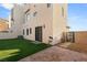 Modern backyard with artificial turf, brick pavers, and sleek sliding door access to the home at 350 Solitude Peak Ln, Henderson, NV 89012