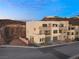 Contemporary home with multiple balconies and garage doors blending modern design with scenic hillside setting at 350 Solitude Peak Ln, Henderson, NV 89012