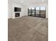 Bright living room with fireplace, large windows with scenic views, and plush carpeting at 350 Solitude Peak Ln, Henderson, NV 89012