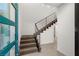 Modern staircase featuring a sleek metal railing and plush carpet steps leading to the upper level at 350 Solitude Peak Ln, Henderson, NV 89012