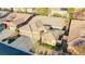 An aerial view of the house, featuring a three-car garage, desert landscaping, and tile roof at 3658 Auckland Castle St, Las Vegas, NV 89135