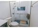 Modern bathroom showcasing a glass-enclosed shower with white tiling, blue accent tiles, and modern fixtures at 3658 Auckland Castle St, Las Vegas, NV 89135