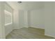 Well lit bedroom with light hardwood flooring, neutral walls, and window with blinds at 3658 Auckland Castle St, Las Vegas, NV 89135
