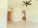 Spacious room boasting sleek flooring, an inviting arched doorway, and a modern ceiling fan at 3658 Auckland Castle St, Las Vegas, NV 89135