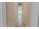 Long hallway with neutral color palette, light hardwood flooring and access to living spaces at 3658 Auckland Castle St, Las Vegas, NV 89135