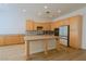 Spacious kitchen featuring natural wood cabinets, stainless steel appliances, granite countertops and island at 3658 Auckland Castle St, Las Vegas, NV 89135