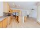Open concept kitchen features natural wood cabinets, stainless steel appliances, and granite countertops at 3658 Auckland Castle St, Las Vegas, NV 89135