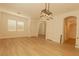 Open concept living room with light hardwood flooring, neutral walls, and updated light fixtures at 3658 Auckland Castle St, Las Vegas, NV 89135