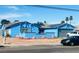 Charming single-story home featuring a blue exterior, desert landscaping, and solar panels at 3664 Rawhide St, Las Vegas, NV 89120