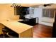 Modern kitchen features a countertop bar, hardwood floors, and stainless steel appliances at 3664 Rawhide St, Las Vegas, NV 89120
