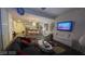 Living room with modern decor including a TV, dark sofa and access to the kitchen at 3722 Las Vegas Blvd # 1205, Las Vegas, NV 89158