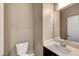 This bathroom features a toilet, vanity with mirror, and modern faucet at 3736 Paseo De Paz Ave, Las Vegas, NV 89115