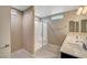 Well-lit bathroom featuring a glass-enclosed shower, double sinks, and a modern design at 3736 Paseo De Paz Ave, Las Vegas, NV 89115