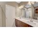 Modern bathroom featuring double sinks, quartz countertops, contemporary lighting, and neutral walls at 3736 Paseo De Paz Ave, Las Vegas, NV 89115