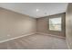 Bright bedroom with neutral carpet and light walls, with a large window at 3736 Paseo De Paz Ave, Las Vegas, NV 89115