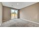 Carpeted bedroom featuring neutral walls, base molding, a sliding glass door to the backyard, and recessed lighting at 3736 Paseo De Paz Ave, Las Vegas, NV 89115