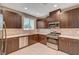 Modern kitchen with dark wood cabinetry, stainless steel appliances, and bright countertops at 3736 Paseo De Paz Ave, Las Vegas, NV 89115