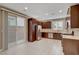 Modern kitchen boasts stainless steel appliances, dark wood cabinetry, and a sliding glass door to the outside patio at 3736 Paseo De Paz Ave, Las Vegas, NV 89115
