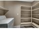 Bright laundry area with a washer, shelving and neutral-colored walls at 3736 Paseo De Paz Ave, Las Vegas, NV 89115