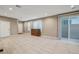 Bright living room with tile flooring, a chest of drawers, and a sliding door to the outside at 3736 Paseo De Paz Ave, Las Vegas, NV 89115