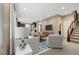 Bright, open-concept living room with staircase and seamless flow to kitchen area at 3736 Paseo De Paz Ave, Las Vegas, NV 89115