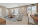 Cozy living room with dining area, bright natural light, and neutral tones at 3736 Paseo De Paz Ave, Las Vegas, NV 89115