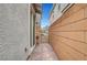 Brick-paved side yard next to a gate and house with stucco exterior at 3736 Paseo De Paz Ave, Las Vegas, NV 89115