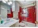 Bathroom with a sink, toilet, walk-in shower behind glass doors and colorful tiled walls at 405 Longtree Ave, Henderson, NV 89011